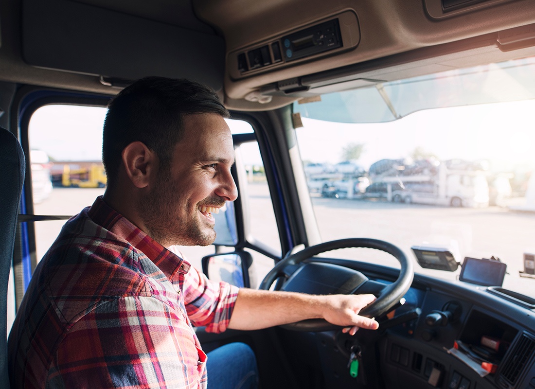 Business Insurance - Cheerful truck driving making a delivery