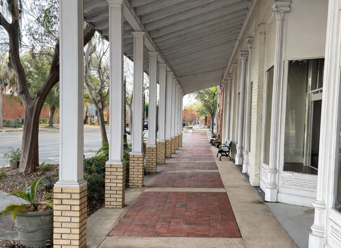 Contact - Exterior brick walkway covered with an awning