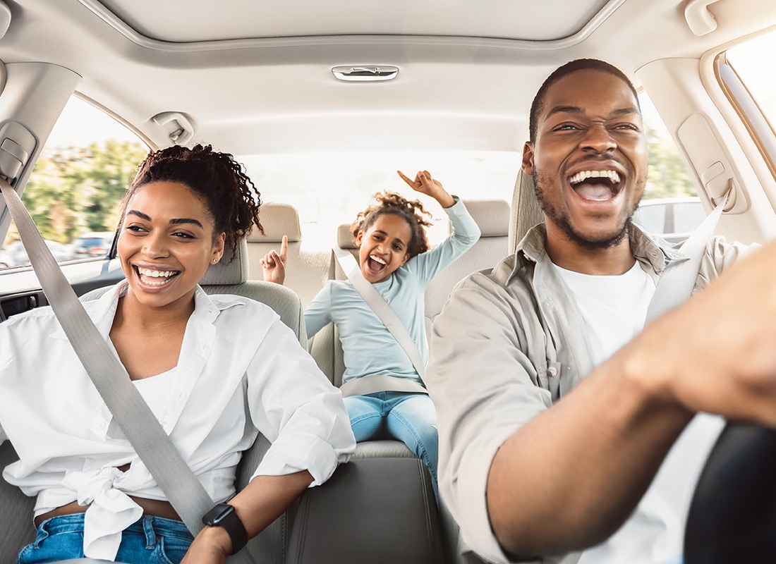 Personal Insurance - Cheerful family singing and laughing during a drive